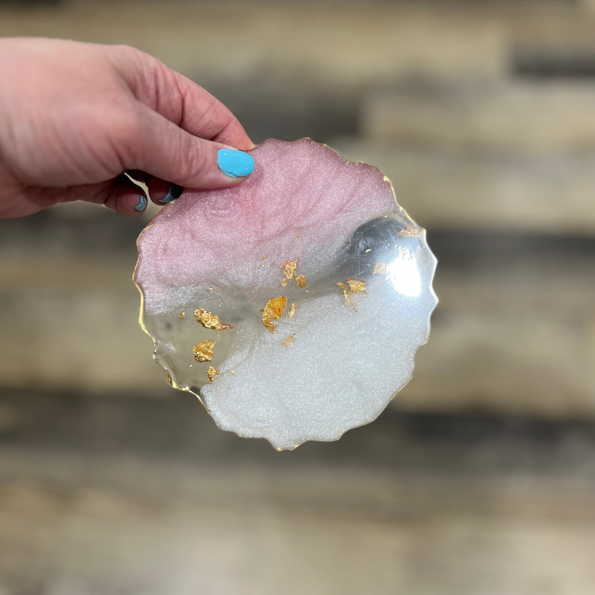 Pink and white resin coaster with gold leaf accents and gold edge, petal-shaped design