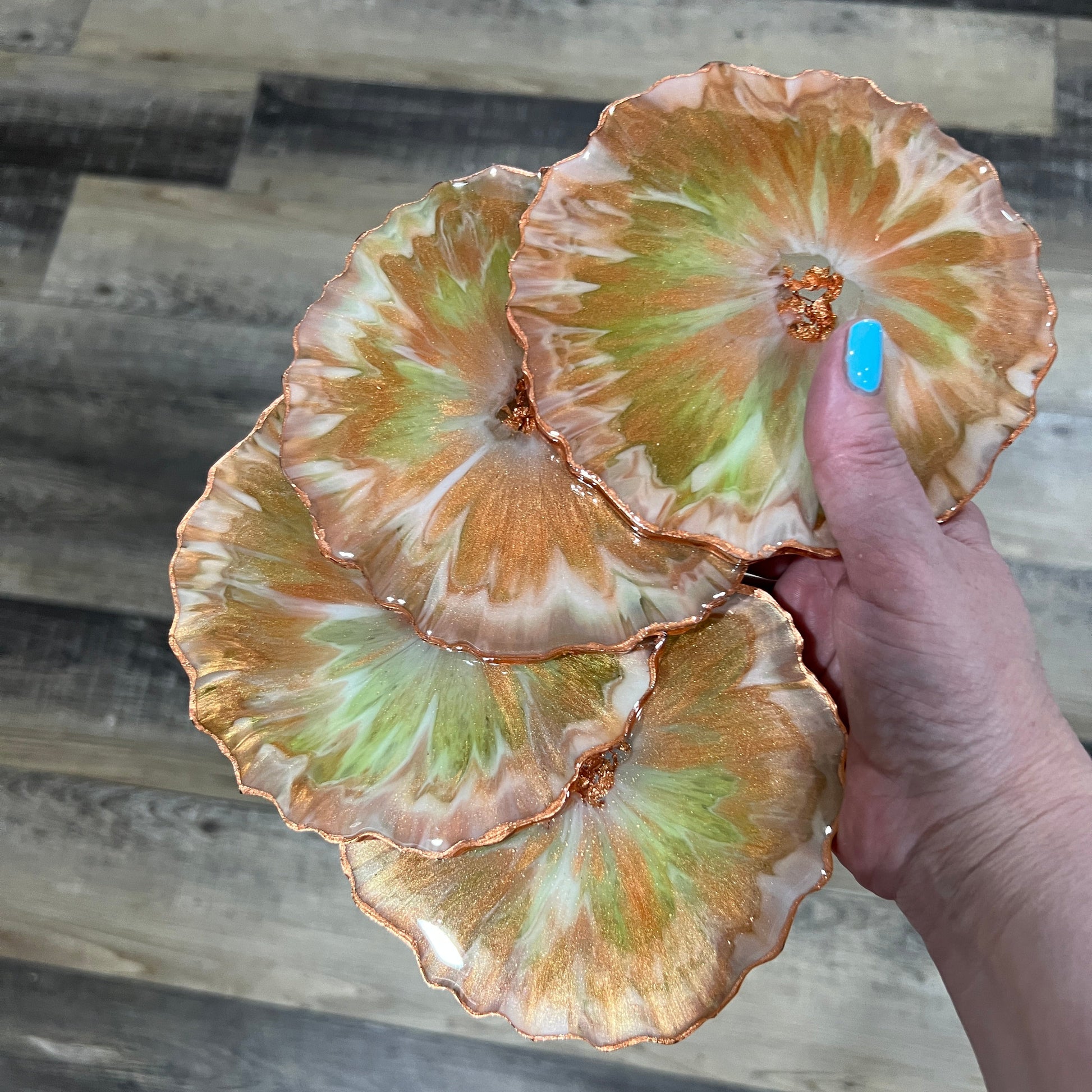 Set of four green and copper resin coasters with metallic leaf edges